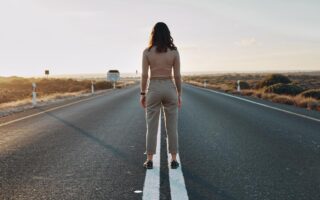 person standing at the start of a new journey