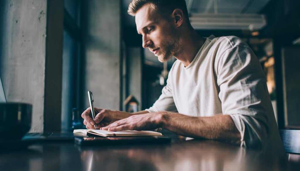 person writing thoughts in a quiet space